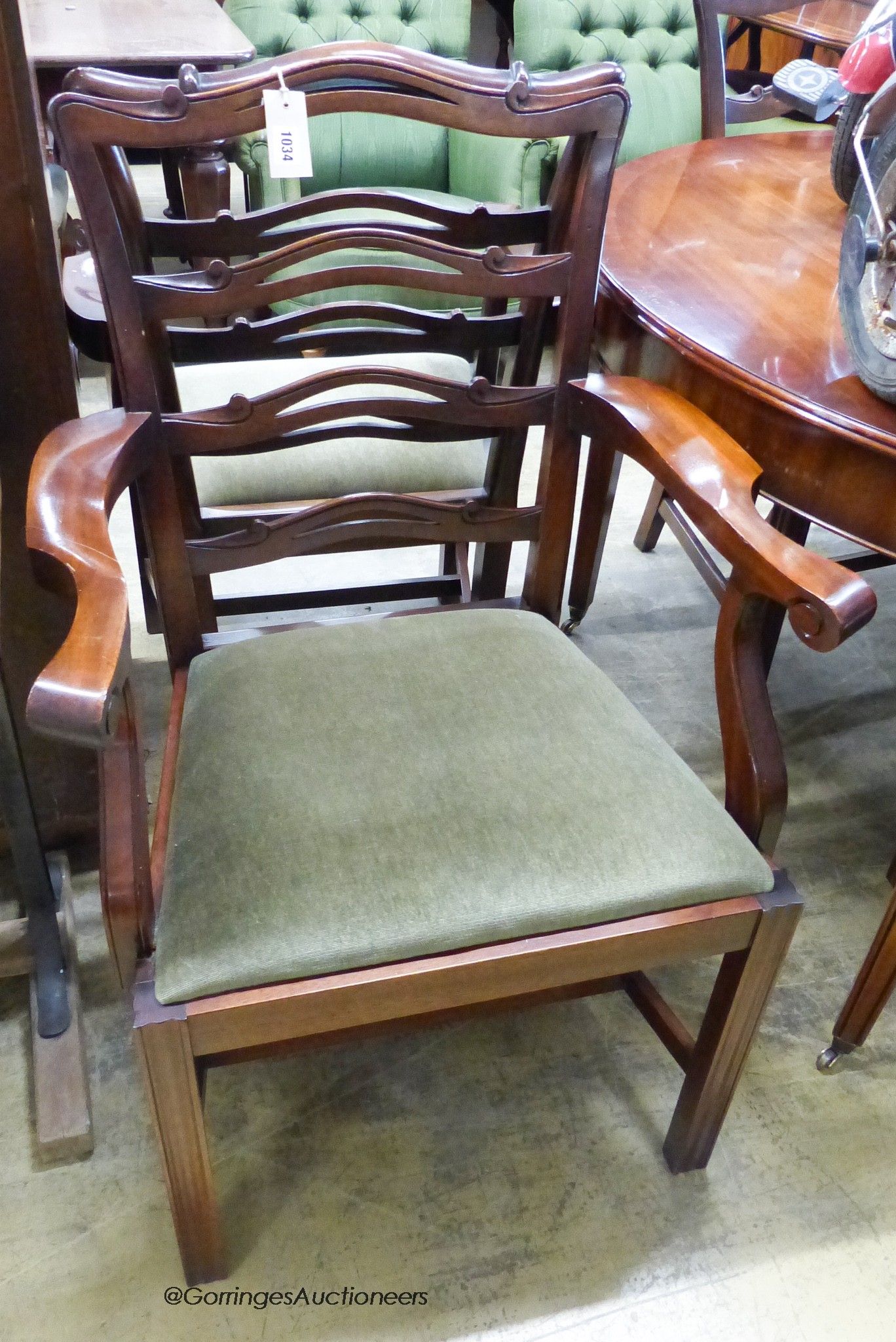 A reproduction George III Style mahogany D-end extending dining table, 236cm extended, 2 spare leaves. W-130, H-74cm. Together with six ladder back dining chairs, two with arms.